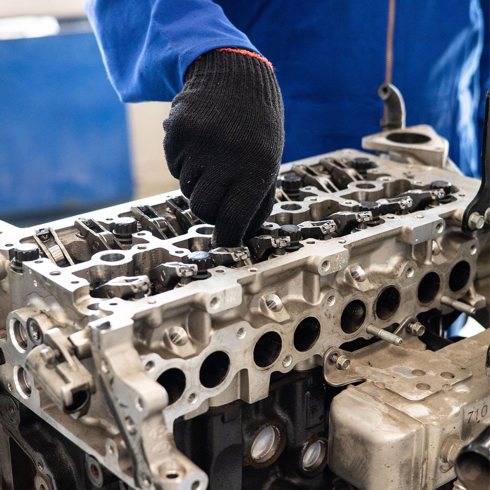 Small engine cylinder head on a workbench